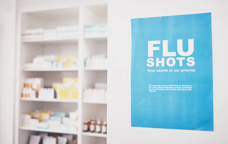 A pharmacy with a sign advertising flu shots