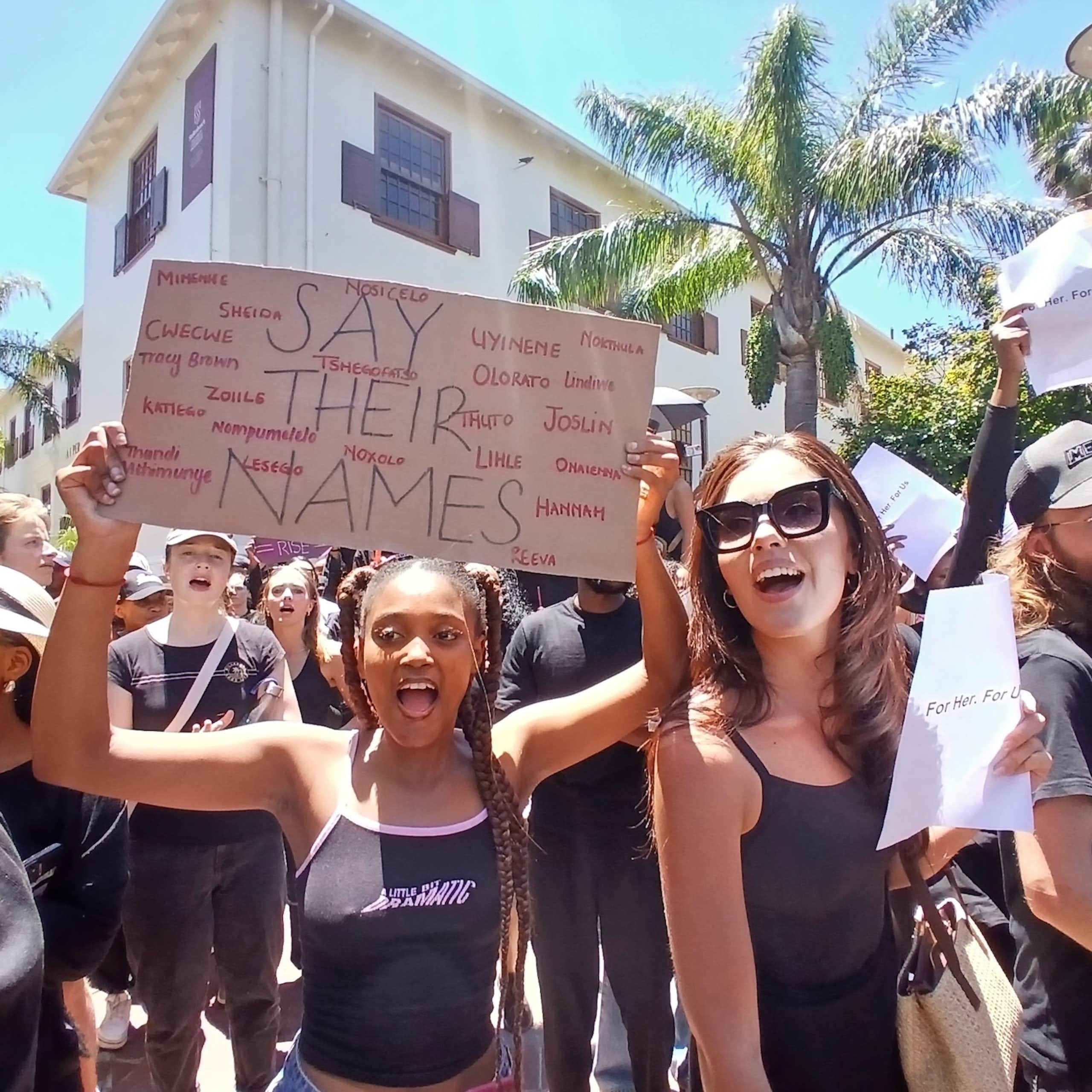 Women protest with a placard that says 'Say their Names' bearing names of victims of femicide