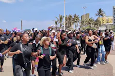 A few hundred women dressed in black march along Durban's beachfront against gender based violence and femicide