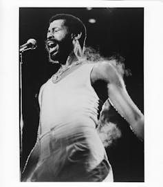 Sabrina Chippie’s and Chappell Roan’s horny pop hits have roots within the bed room ballads of Teddy Pendergrass and Philly soul 1 Black-and-white photo of singer wearing white undershirt singing in front of microphone, with steam coming off his body