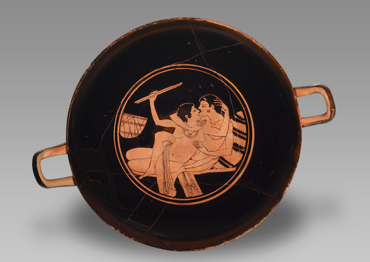 Pottery showing man and woman at ancient party.