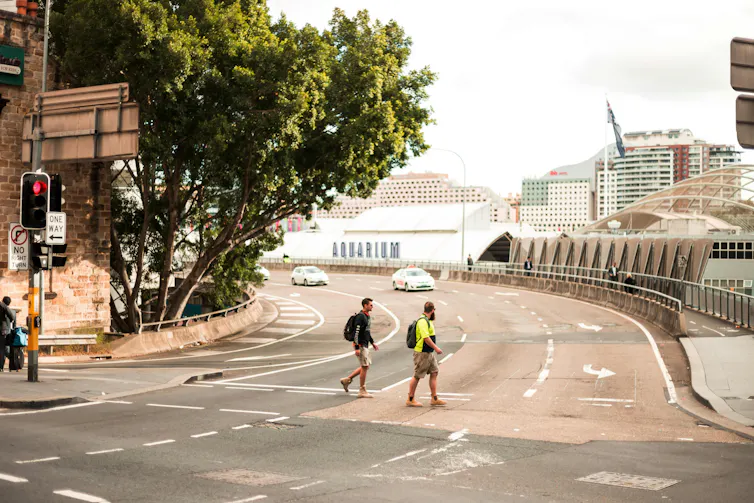 people walking across road in sydney.