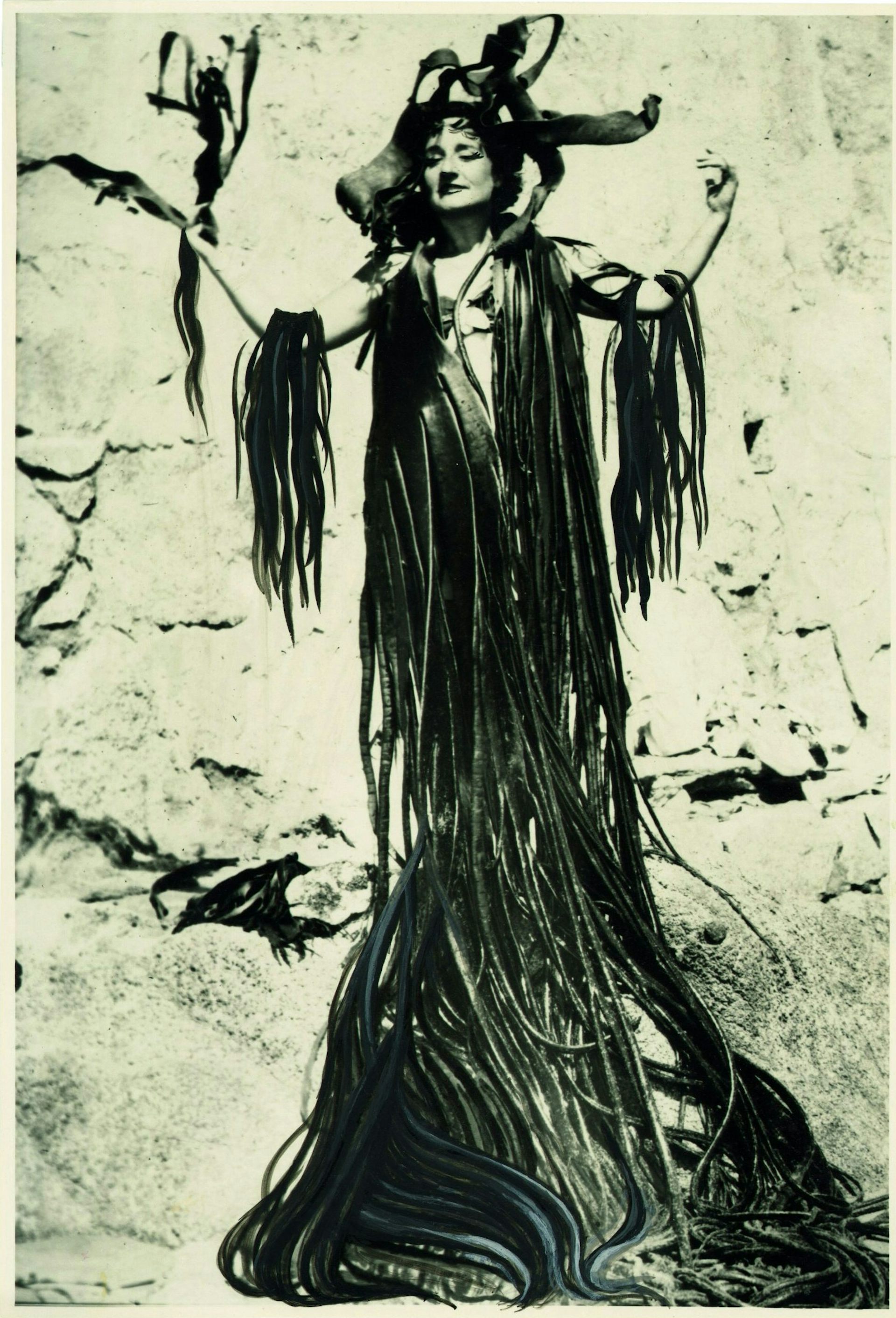 Black and white photograph of a woman covered in algae.