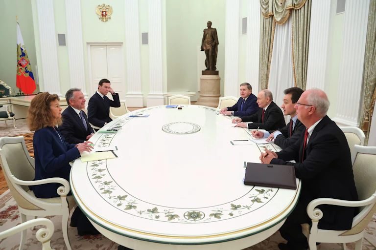Russian president Vladimir Putin sits at his long table with US negotiators Steve Witkoff and Jared Kushner.