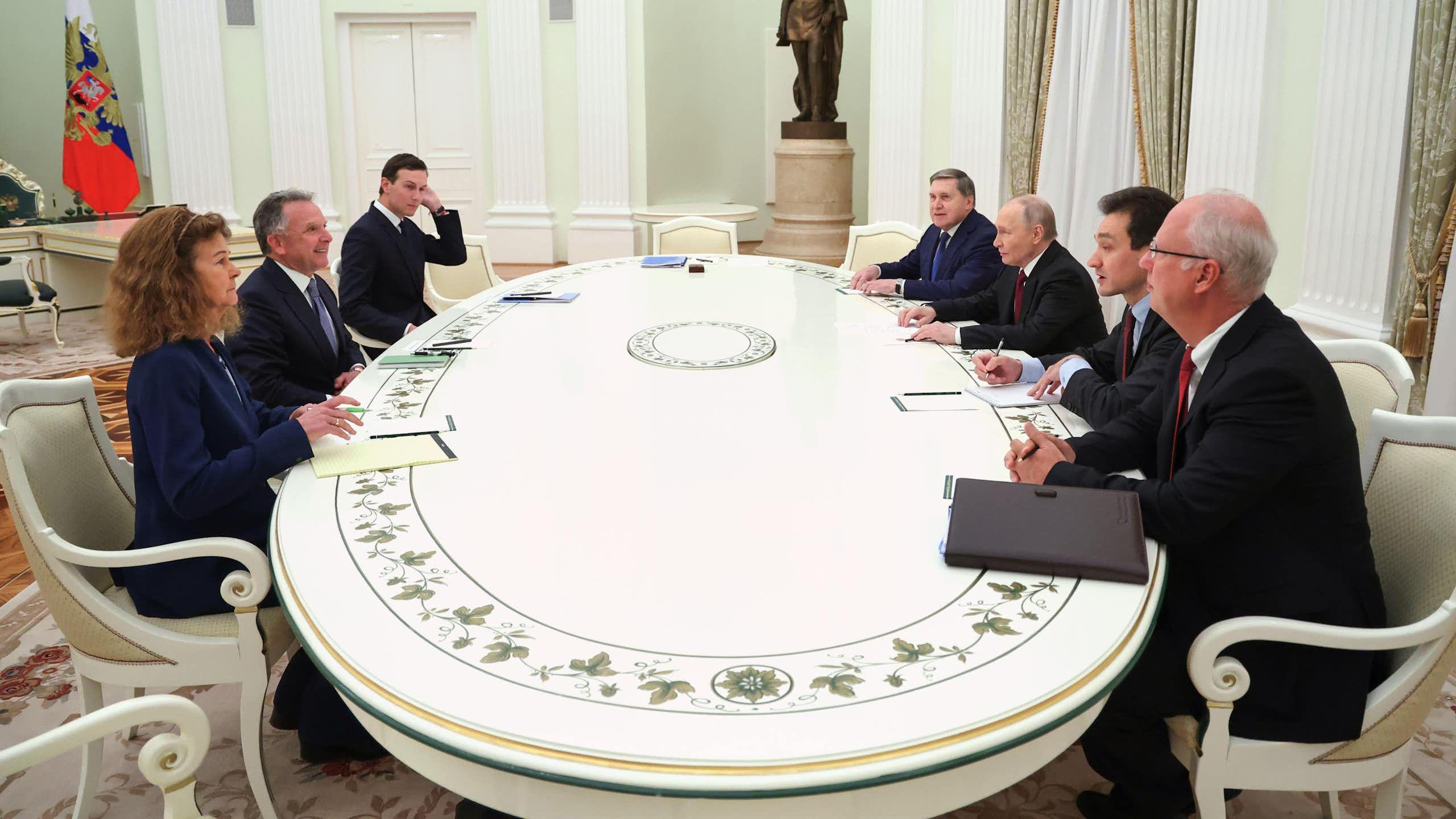 Russian president Vladimir Putin sits at his long table with US negotiators Steve Witkoff and Jared Kushner.