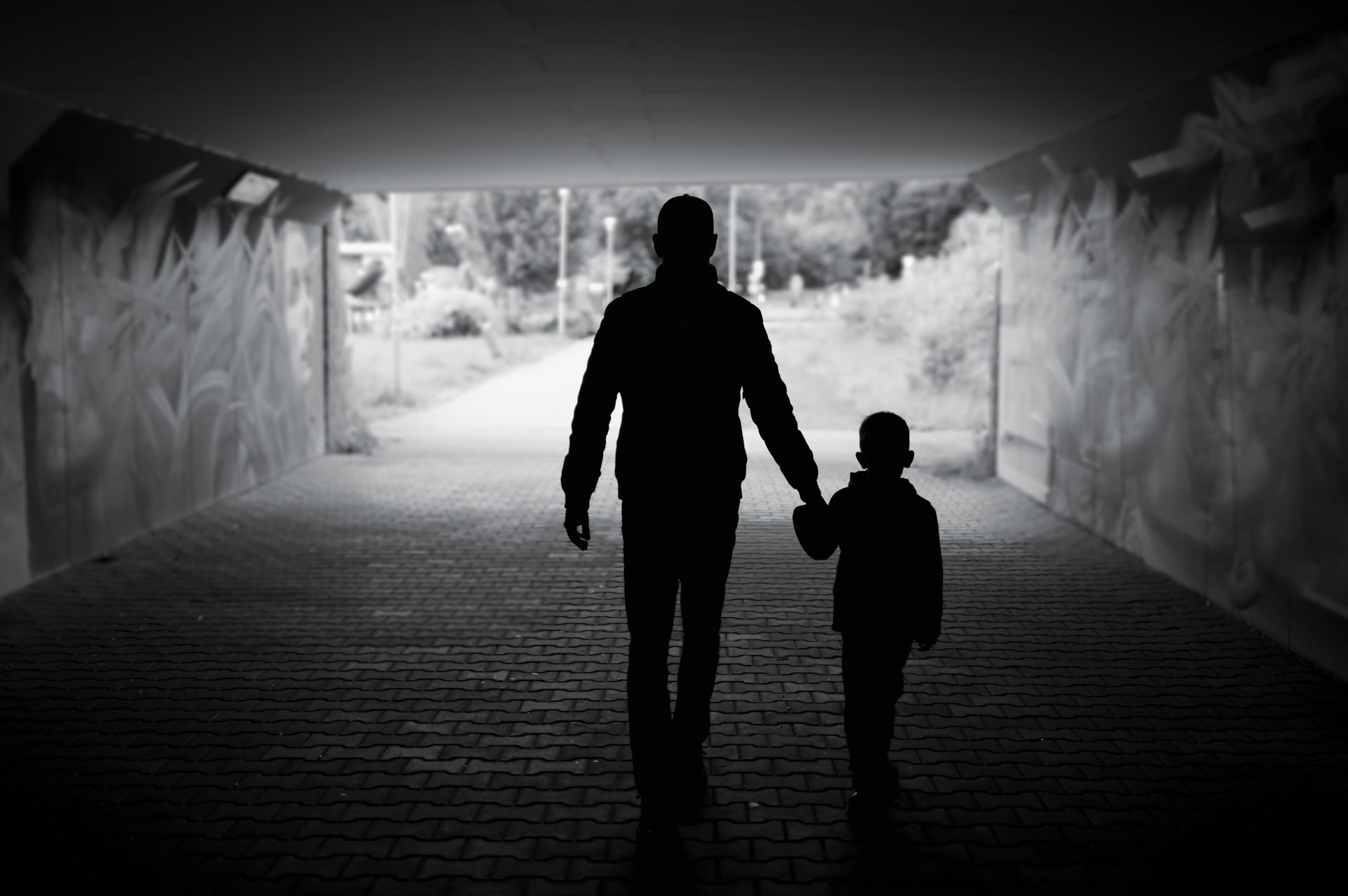 Silhouetted man and child