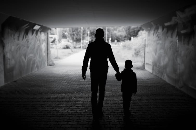 Silhouetted man and child