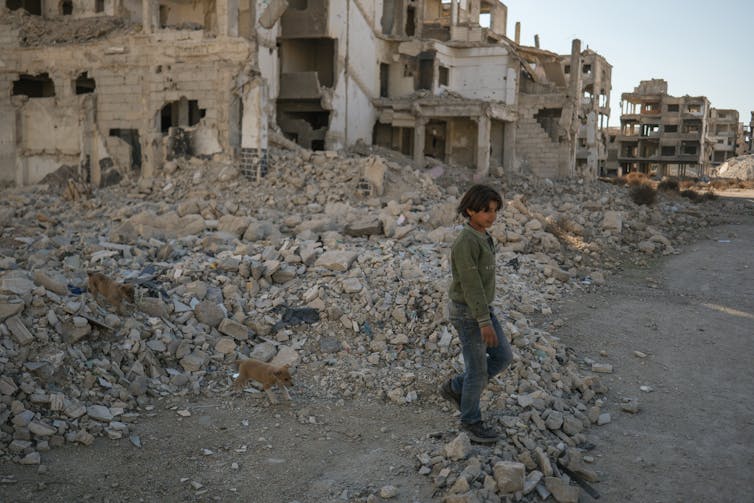 Hope and hardship have pushed Syrian refugee returns – however many head again to destroyed houses, land disputes 1 A child walks through rubble.