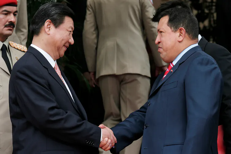 Xi Jinping shaking hands with Hugo Chávez.