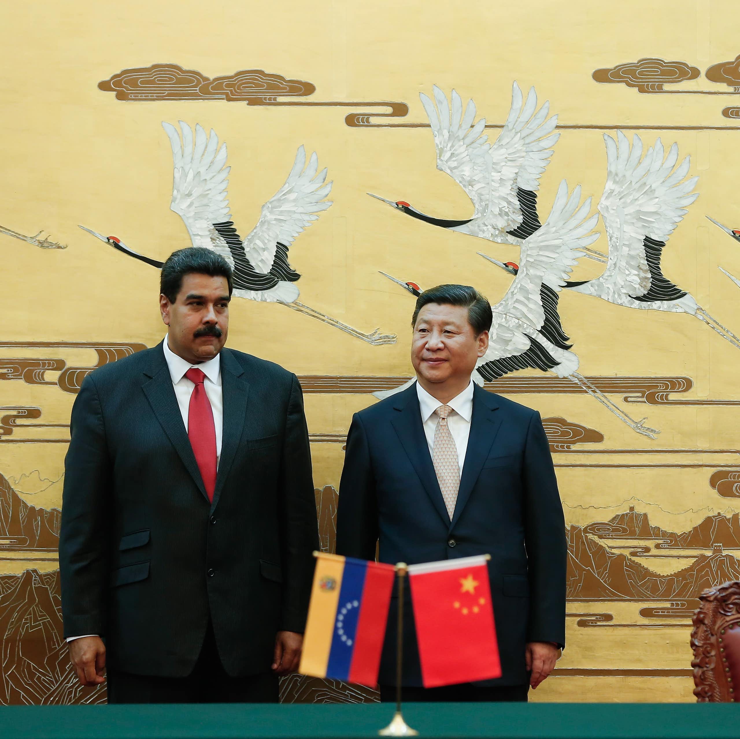 Xi Jinping and Nicolás Maduro standing next to each other.