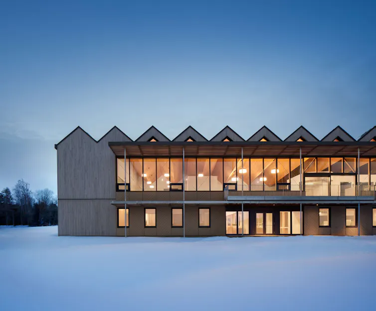 A wood building in a winter landscape