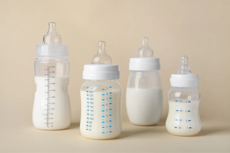Bottles of infant formula in a row.