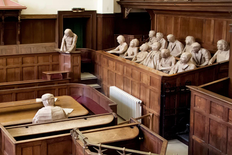 A representation of a courtroom with mannequins replacing the judge, witness and jury