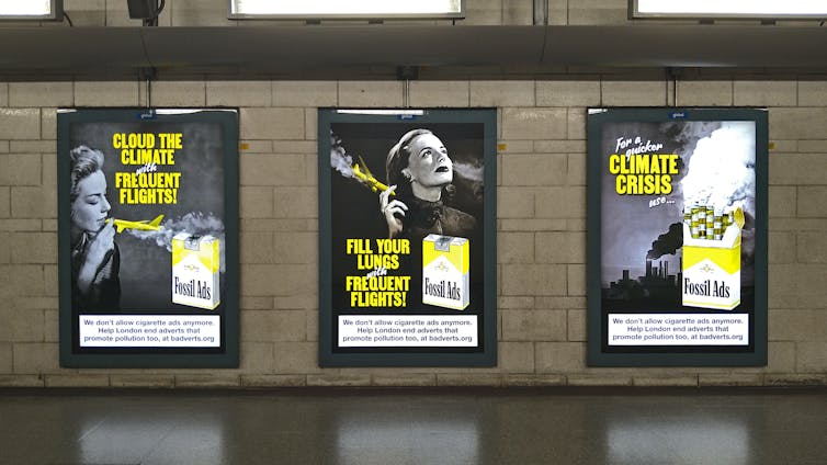 three fossil ads posters on tube station wall