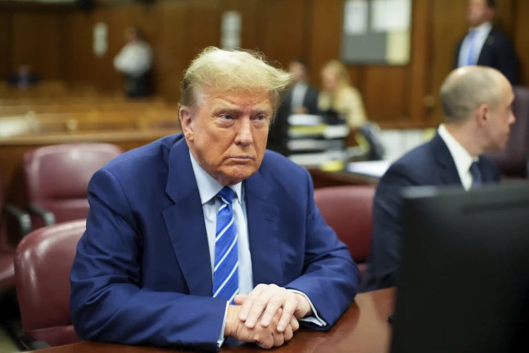 Donald Trump sits in a Manhattan courthouse during jury selection for a cover-up case.