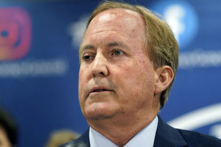 Texas Attorney General Ken Paxton makes a statement at his office.