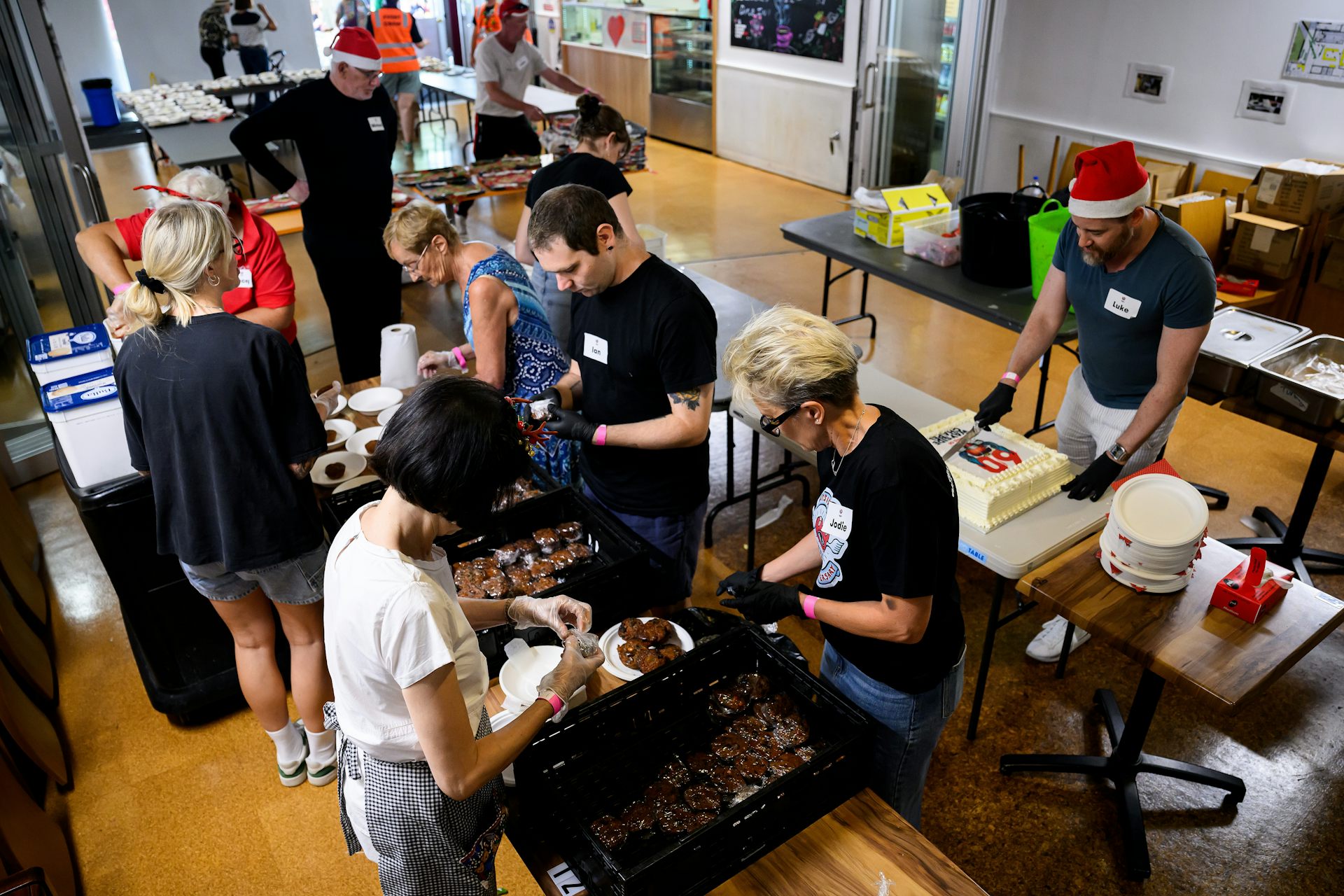 Volunteers prepare Christmas puddings for members of the community at the annual Christmas Street Party lunch at Wayside Chapel in Sydney, December 25 2024.