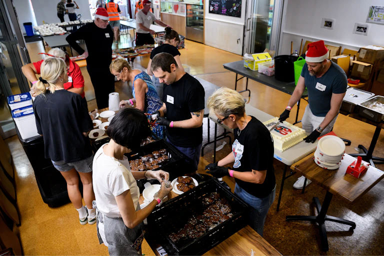 Volunteers prepare Christmas puddings for members of the community at the annual Christmas Street Party lunch at Wayside Chapel in Sydney, December 25 2024.
