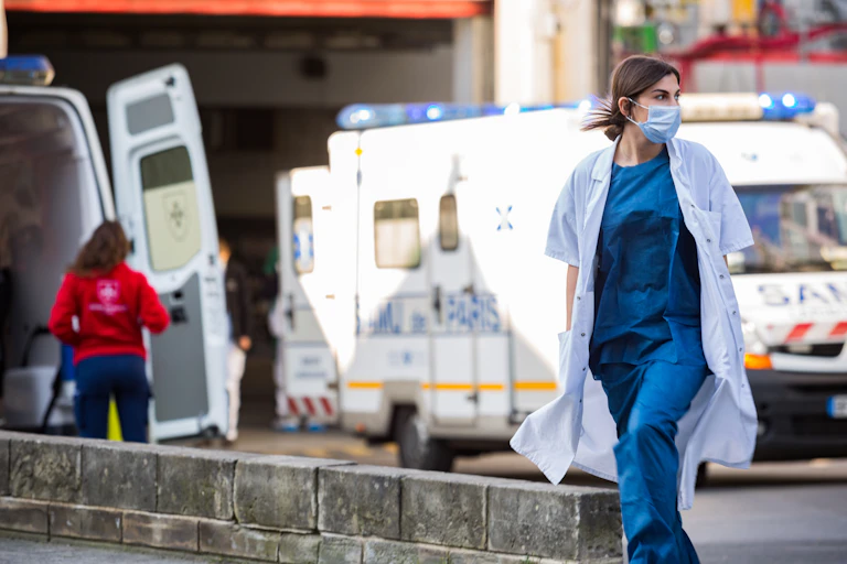 Médecin devant un véhicule d'urgence.