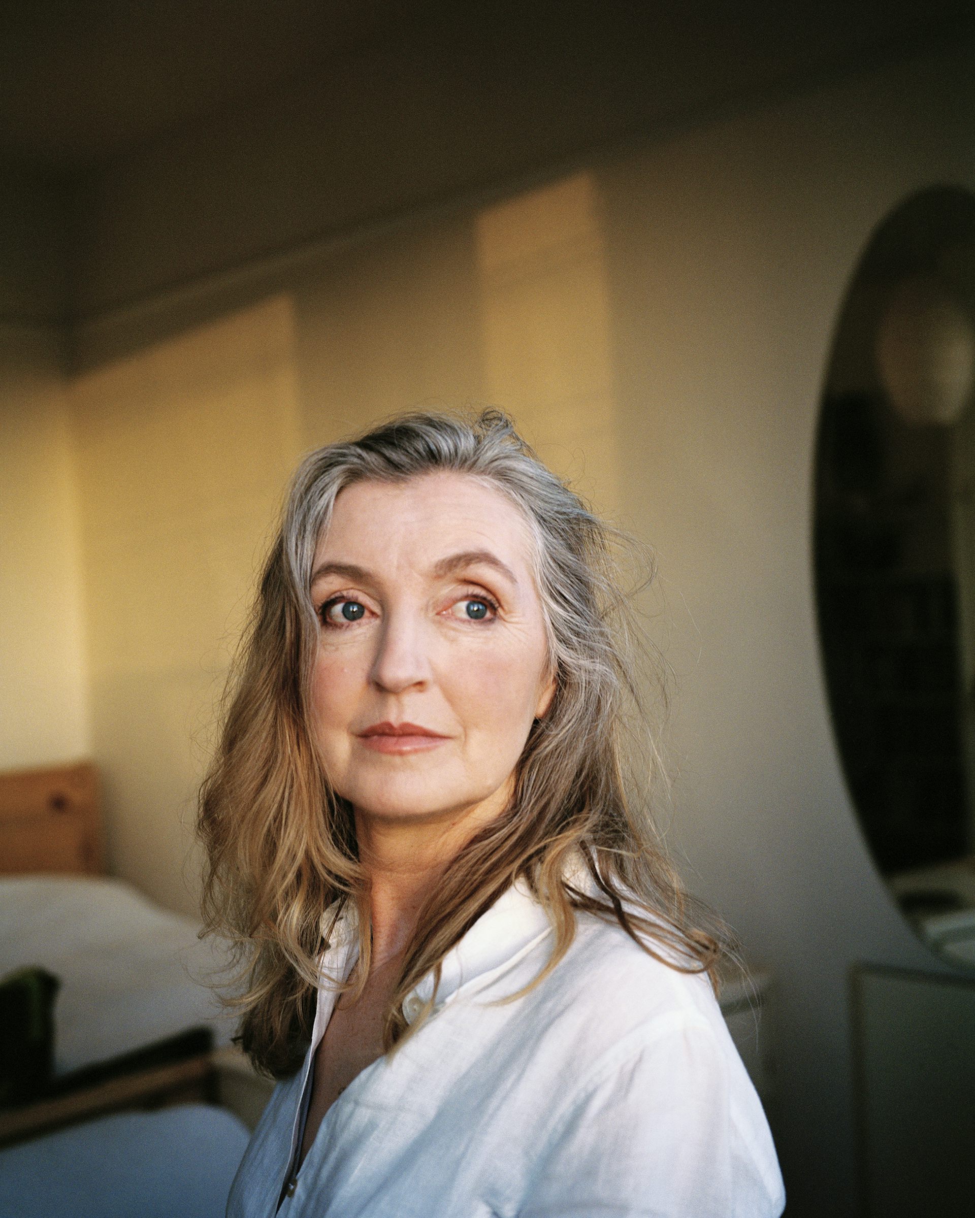 portrait shot of Rebecca Solnit woman long hair wearing white shirt looking at cam