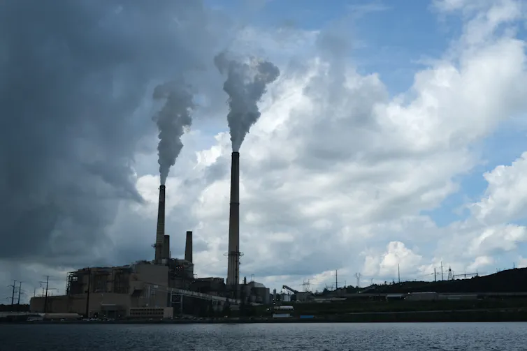 A large industrial site with two tall smokestacks.