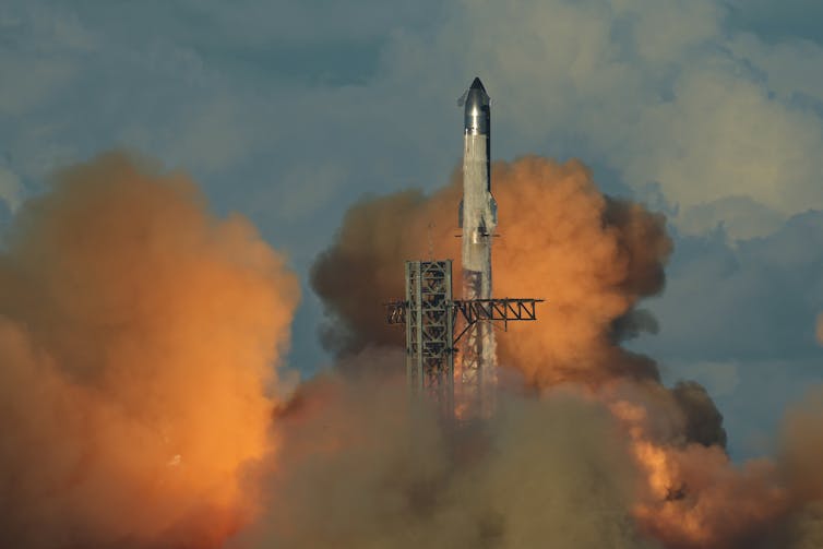 The primary fashionable rocket introduced 100 years in the past, starting a century of each inventions and demanding situations for spaceflight 2 A large rocket launching into the sky, surrounded by plumes of smoke.