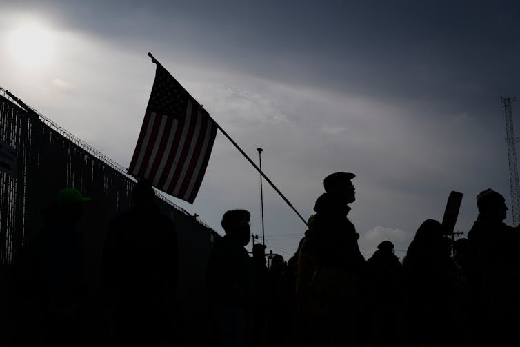 Protesters gather in front of a federal building.