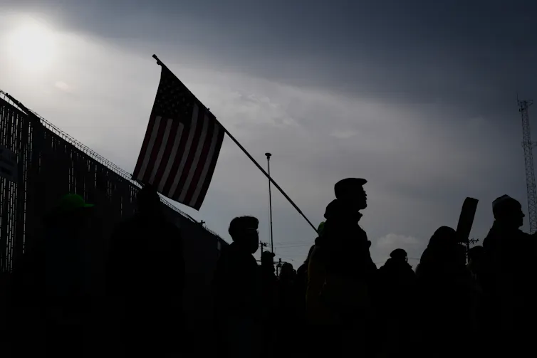Protesters gather in front of a federal building.