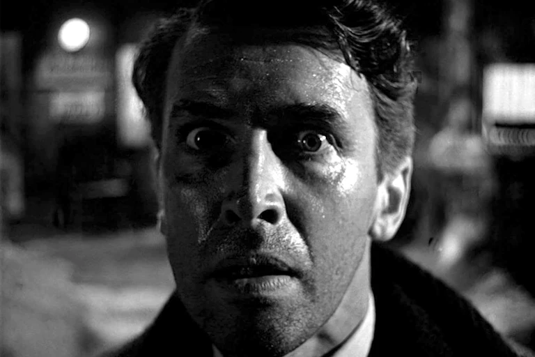 Black-and-white close-up of the face of a distraught young man.