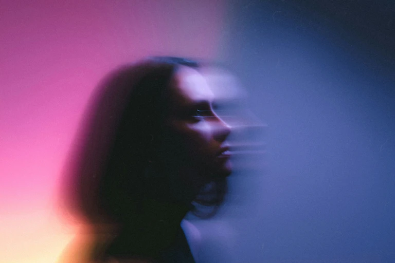 Blurry photo of a woman in moody lighting