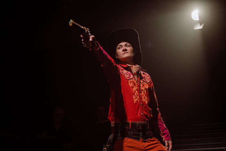 Billington raises a gun.