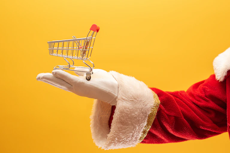 Mini trolley on Santa's white-gloved hand.