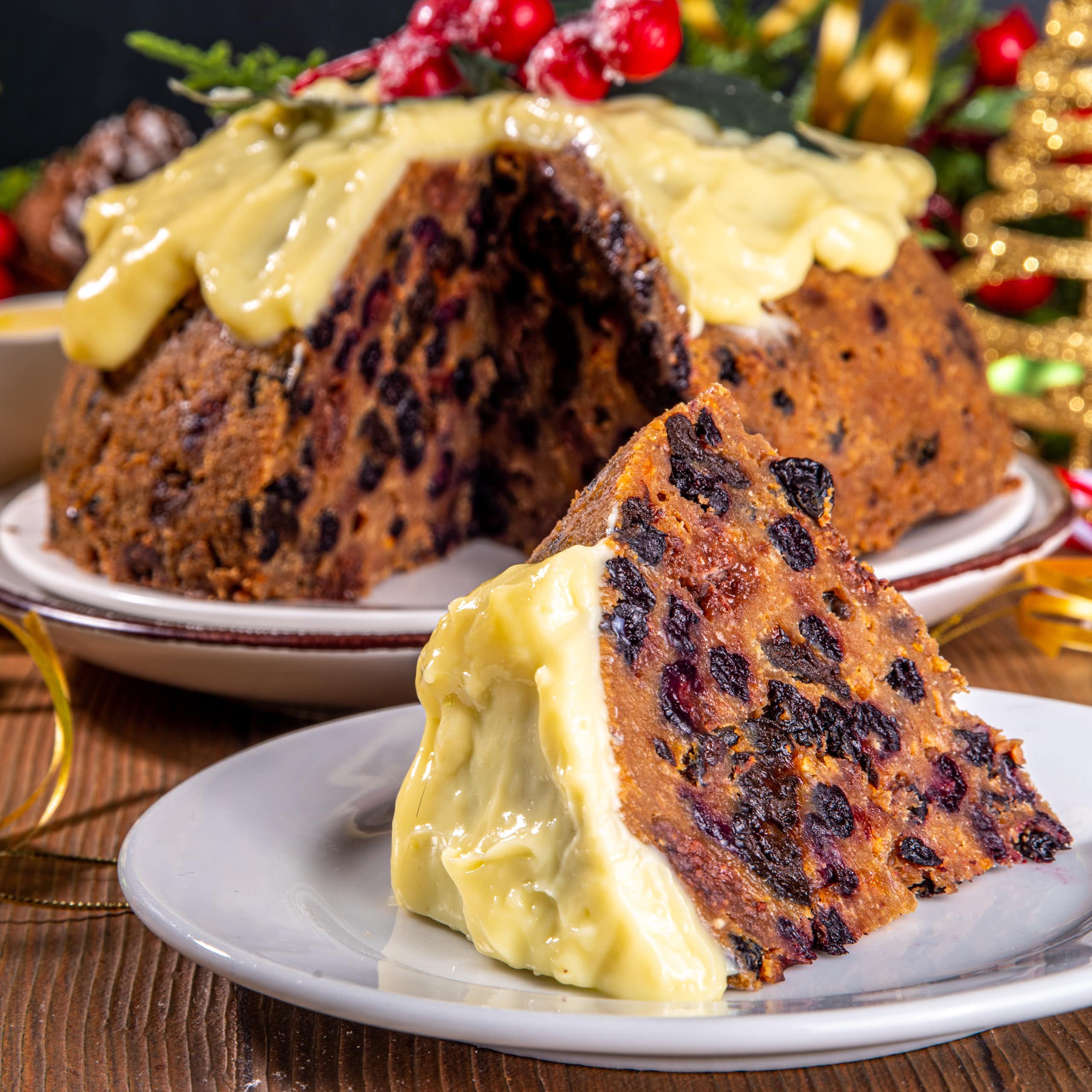 Christmas cake surrounded by Christmas decorations.