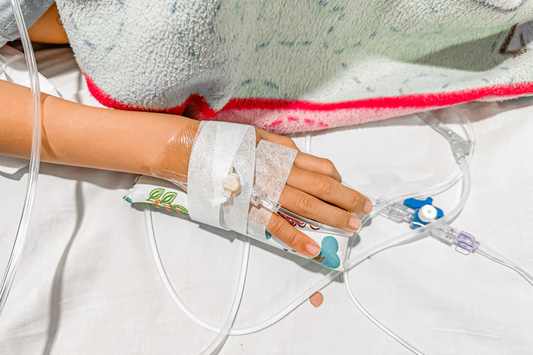 A child's hand with a cannula.