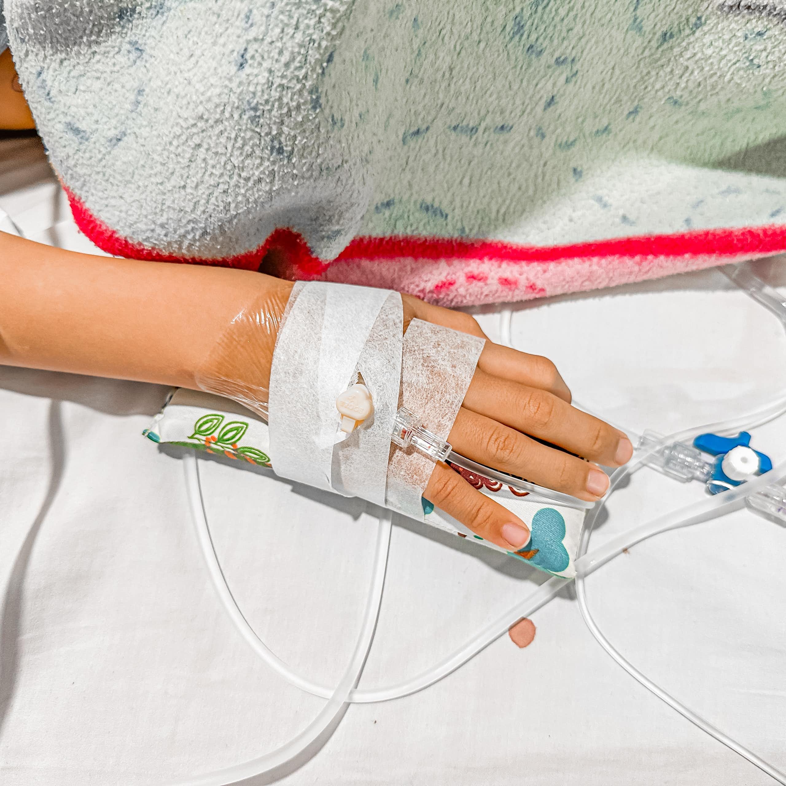 A child's hand with a cannula.