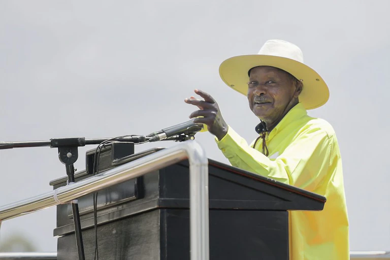 Yoweri Museveni gestures with his left hand during a campaign speech.