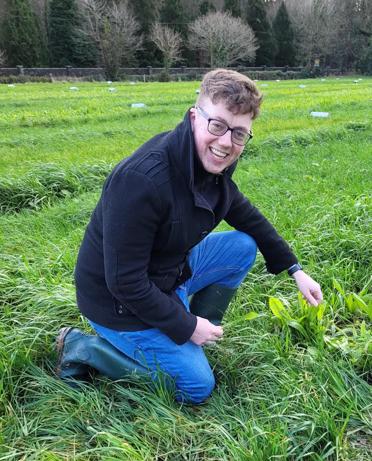 A man in a field kneeling down.