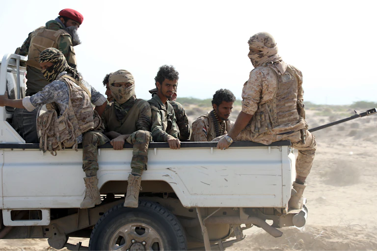 Fighters of the the Southern Transitional Council ride a truck.