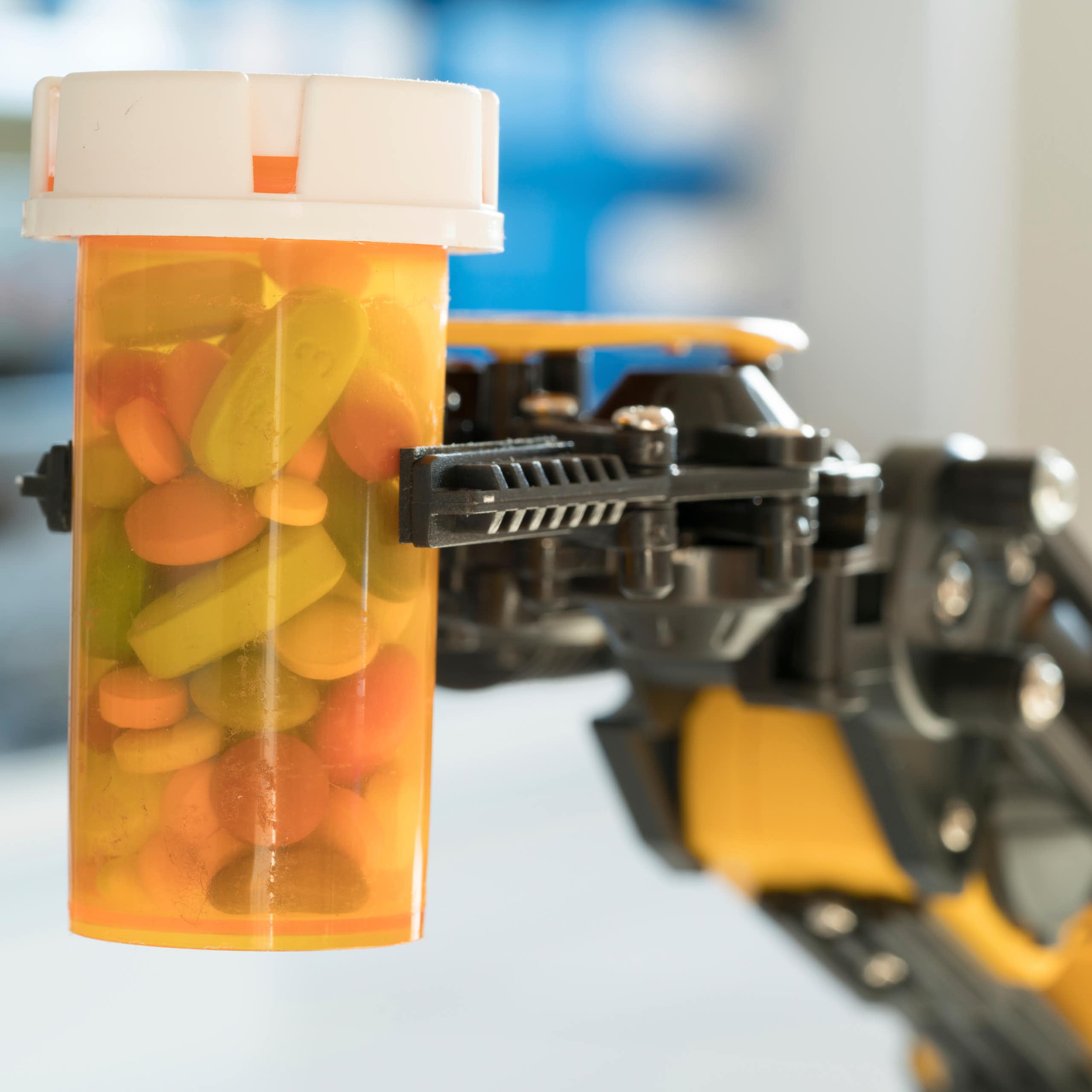 Robotic arm holding bottle of pills