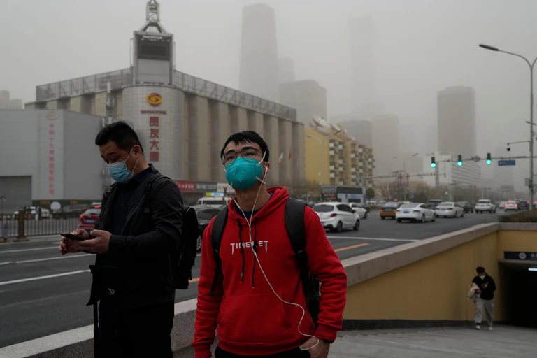 People in China wearing masks because of a major dust storm.