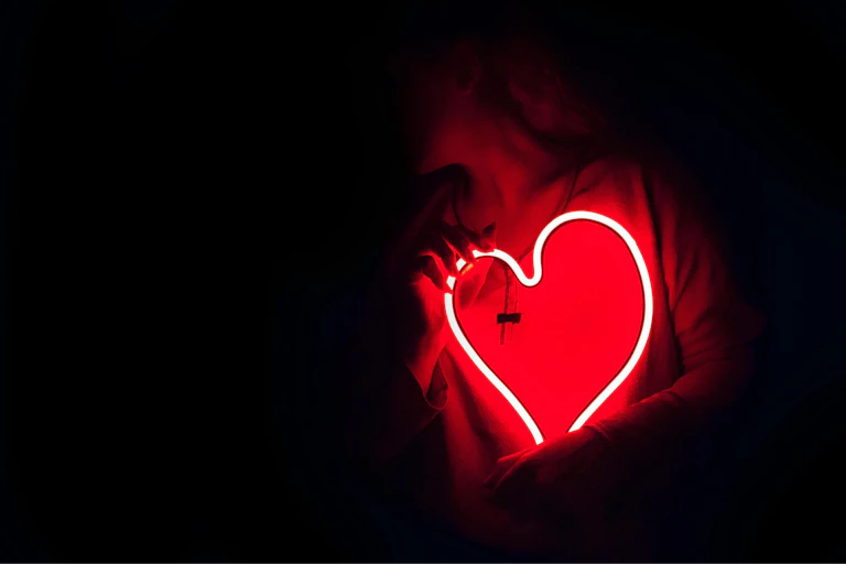 A neon red hard against a dark background.