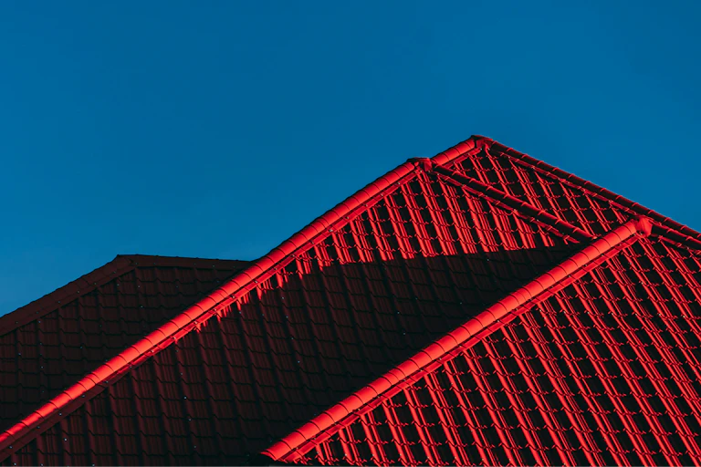A reef tiled roof against a blue sky