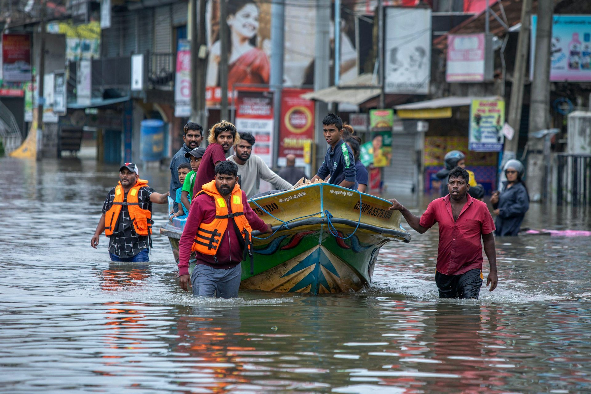 People rescued from flooded homes in a boat