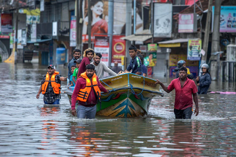 People rescued from flooded homes in a boat