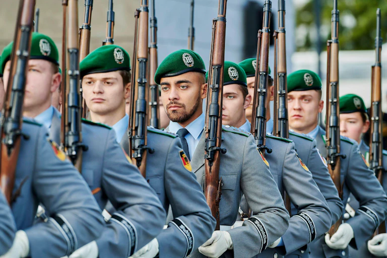 A rank of German soldiers marching.