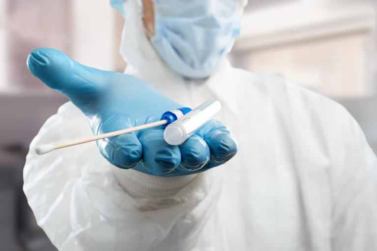 Medical lab assistant holds out donor suitability test for artificial insemination