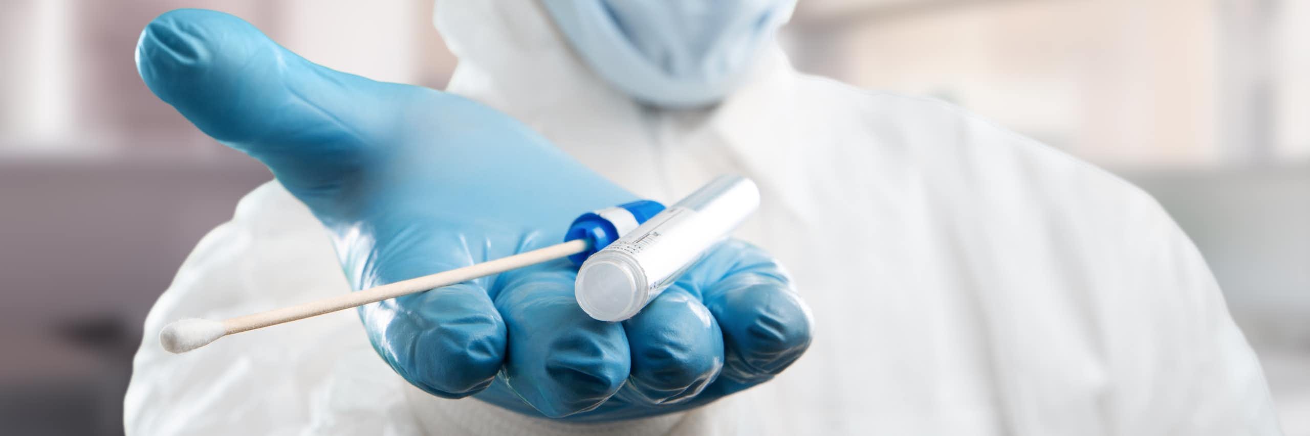 Medical lab assistant holds out donor suitability test for artificial insemination