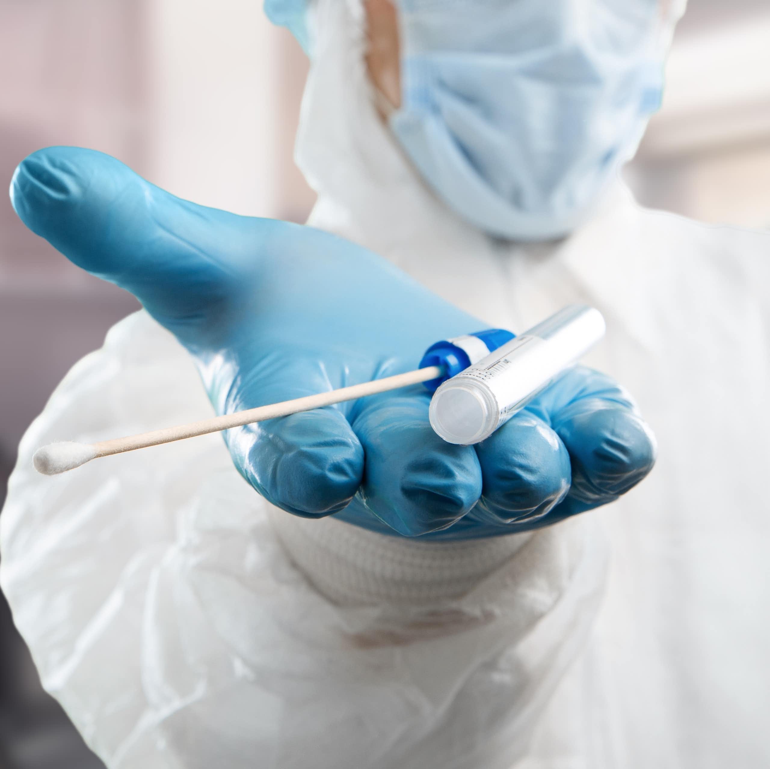 Medical lab assistant holds out donor suitability test for artificial insemination