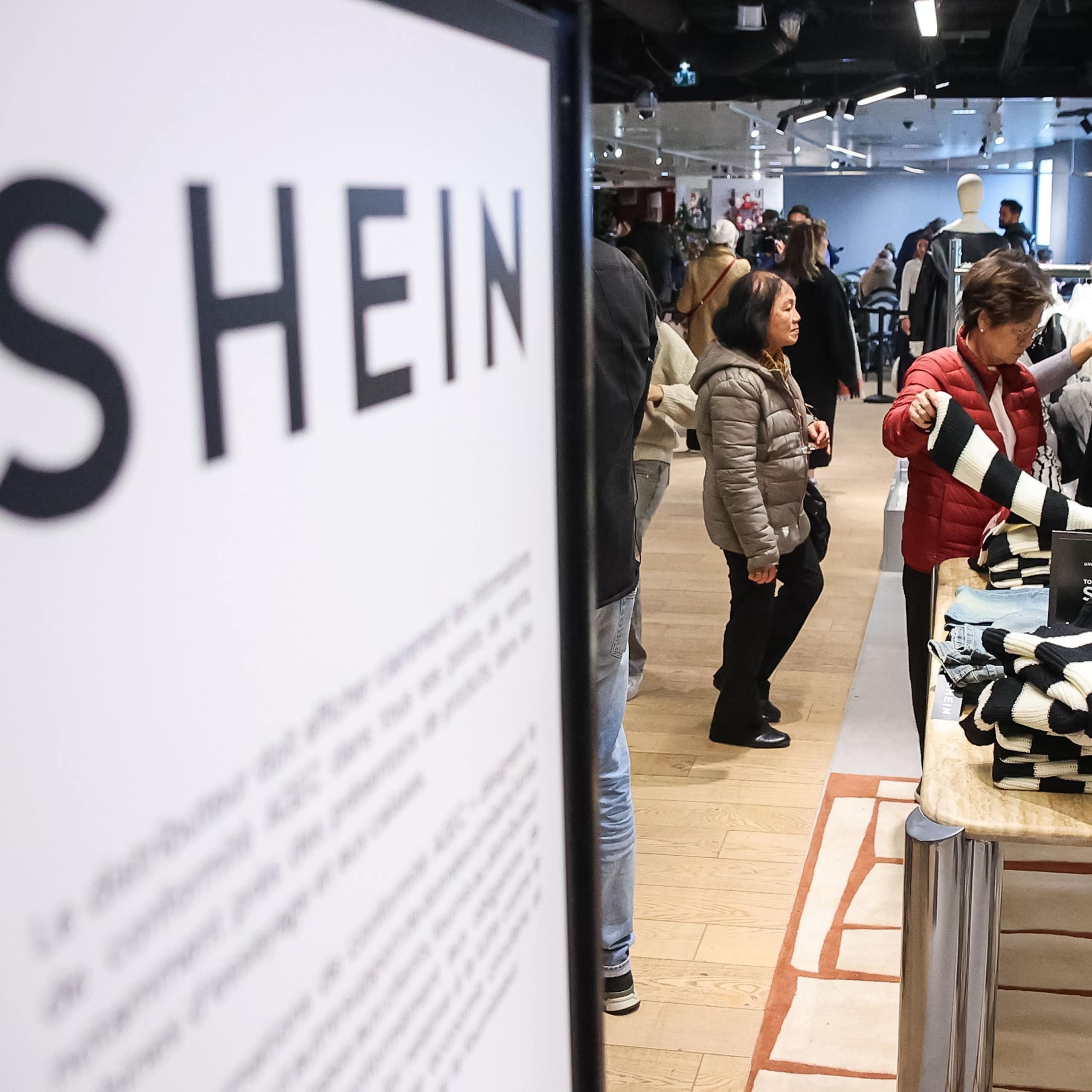 shoppers browse the clothes at the first shein store in paris.
