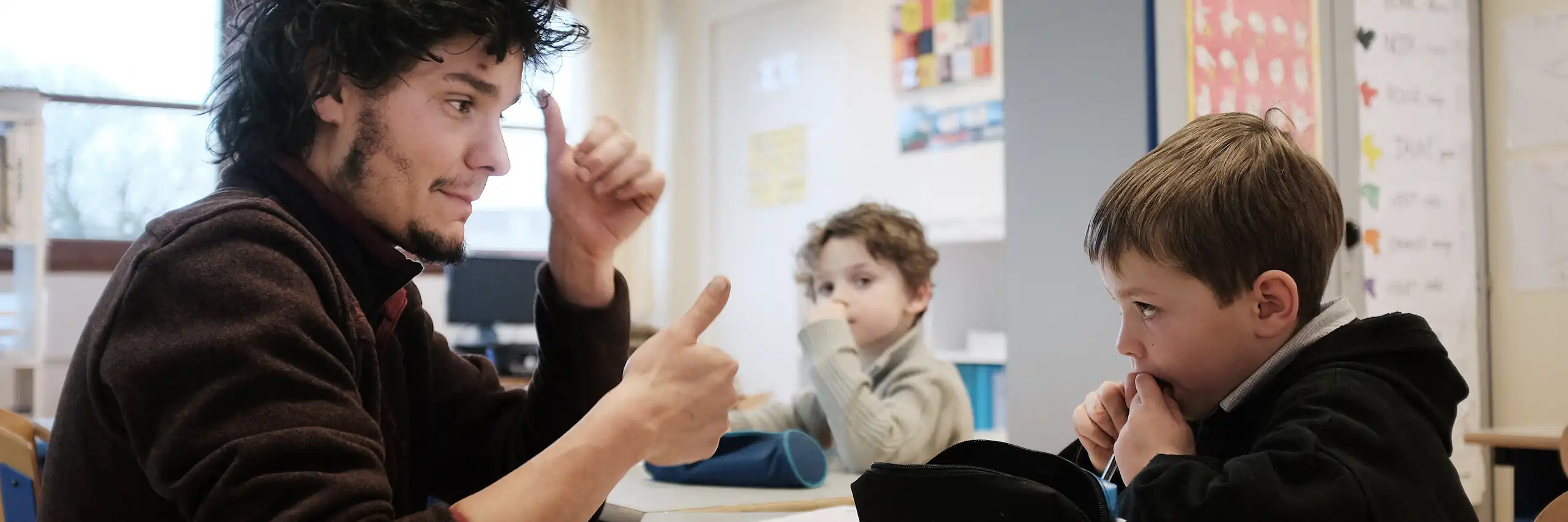 Un professeur des écoles enseigne la langue des signes à des élèves malentendants dans un établissement de Rennes, en 2015.